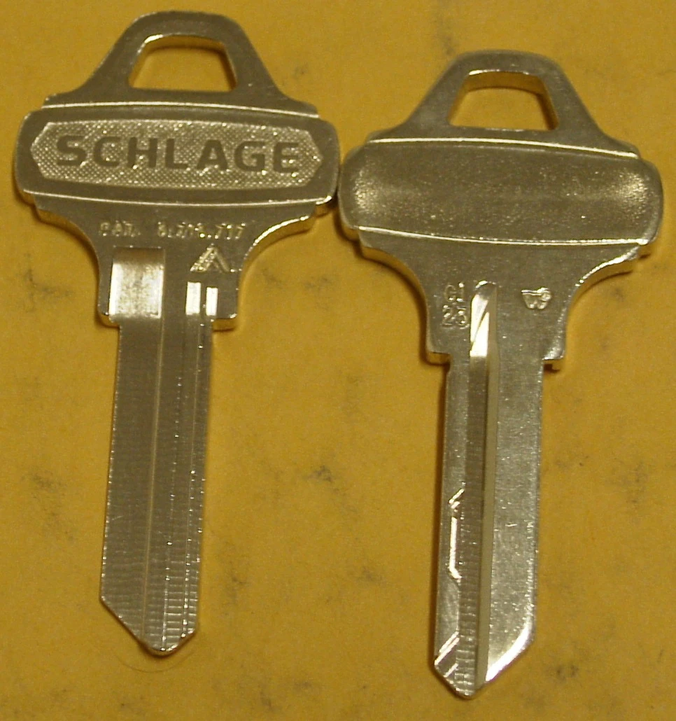 Two Schlage Everest C123 key blanks side by side, one showing the Schlage logo and a patent stamp on the bow.